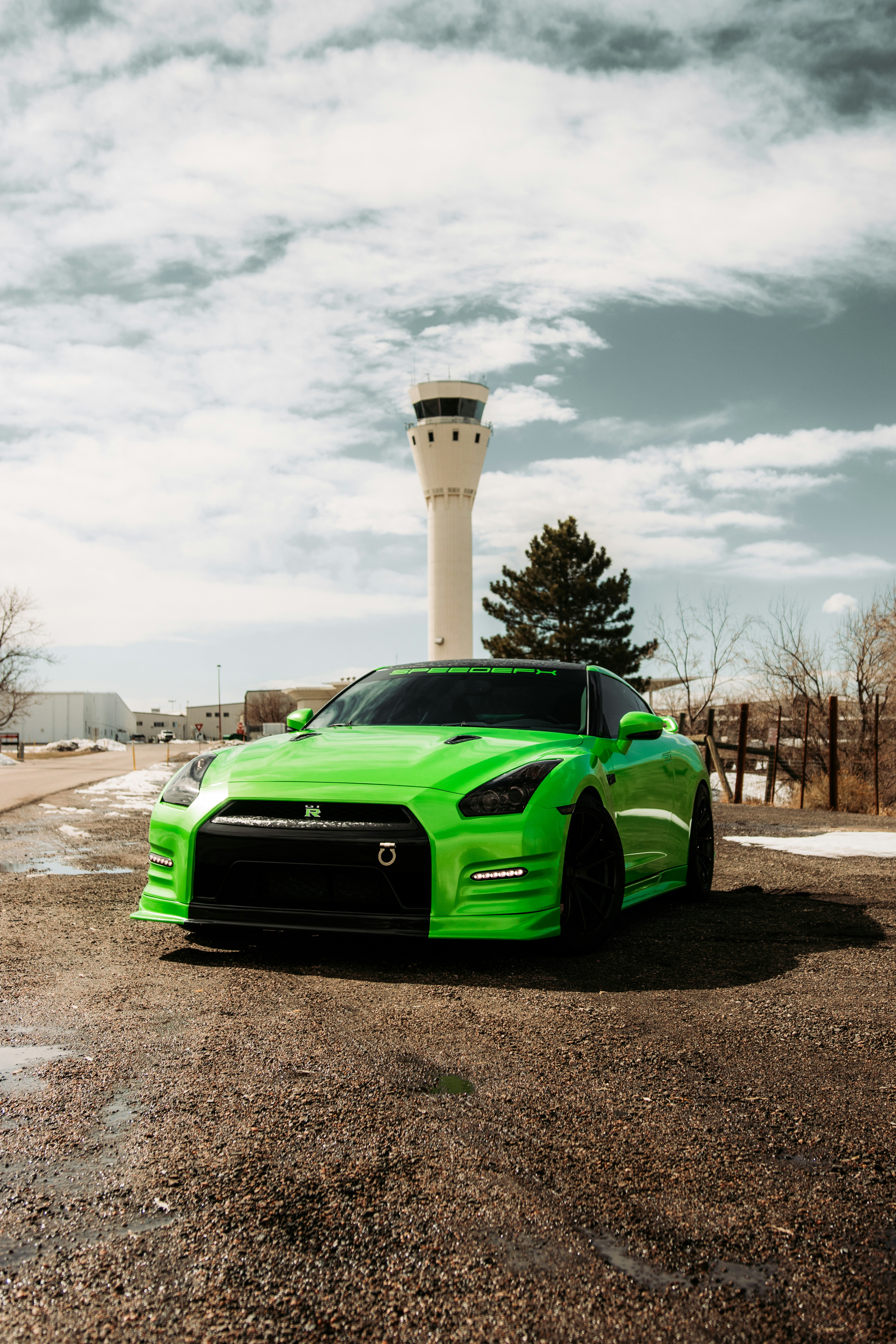 green chevrolet camaro parked on the side of the road